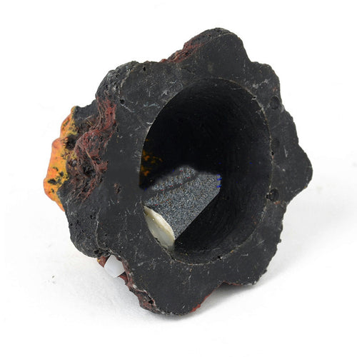 Black mineral specimen with a central hole on a white background