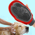 Red and gray grooming brush being used on a dog with a blue background