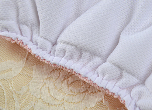 Close-up of a textured white fabric with a floral patterned surface underneath.