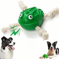 Green dog toy with eyes and a rope, featuring a dog interacting with it on a white background.