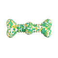 Green and yellow bone-shaped toy on a white background