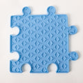 Blue puzzle piece-shaped mat with a geometric pattern on a white background