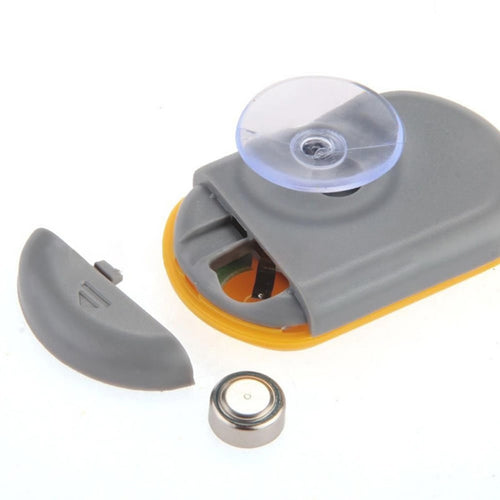 Mechanical device with a suction cup and additional components on a white background